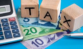 A calculator on a table with Canadian currency underneath