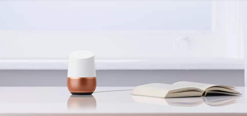 An open book beside a google home mini