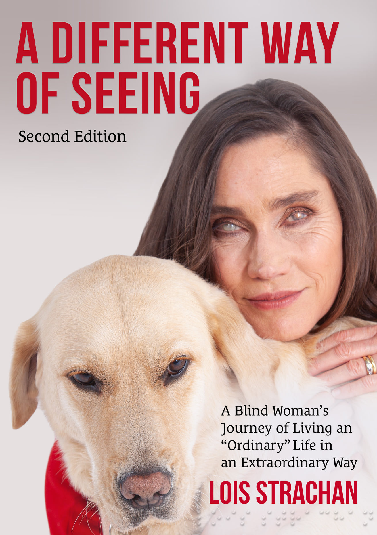 A book cover with Lois Strachan and her guide dog Fiji. The title reads "“A Different Way of Seeing. Second Edition. A Blind Woman’s Journey of Living an Ordinary Life in an Extraordinary Way.” 