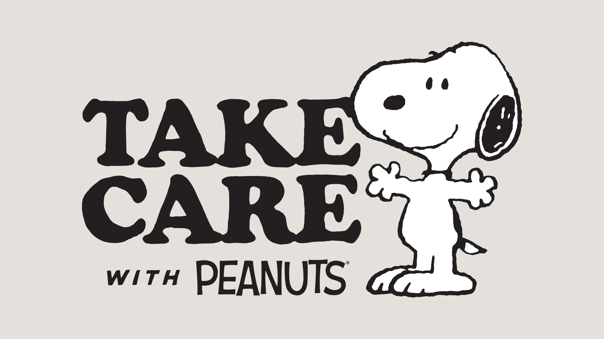 A sign that reads, take care with peanuts as Snoopy stands beside