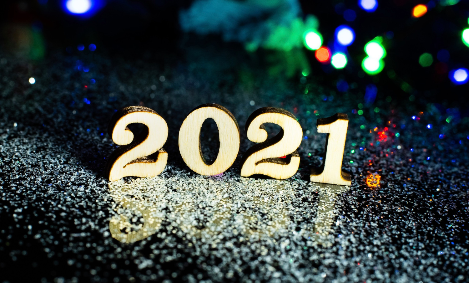 Wooden numbers on table that read 2021. 