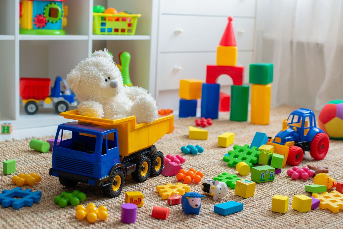 A bunch of toys on the ground in a kids room