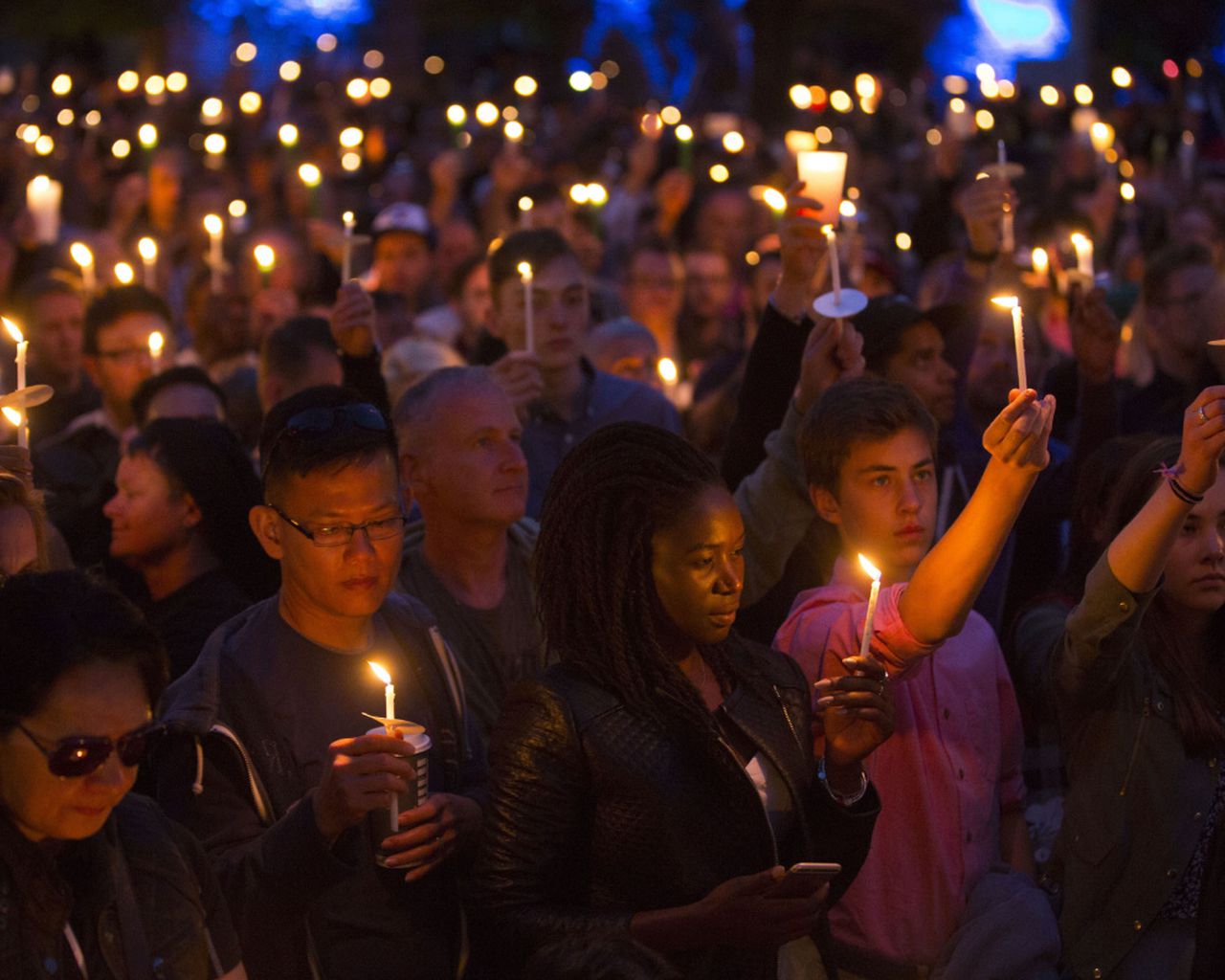 People gathering around in a vigil
