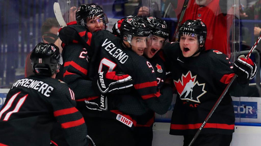 Team Canada world juniors celebrating after scoring a goal