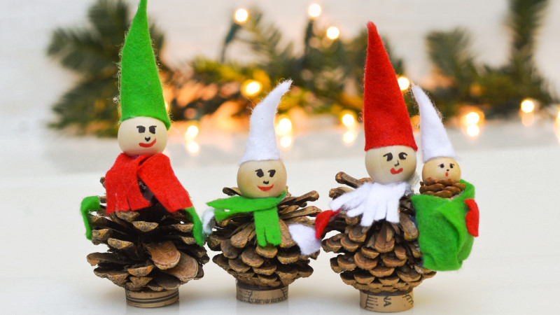 Pinecones that have been crafted into Christmas elves