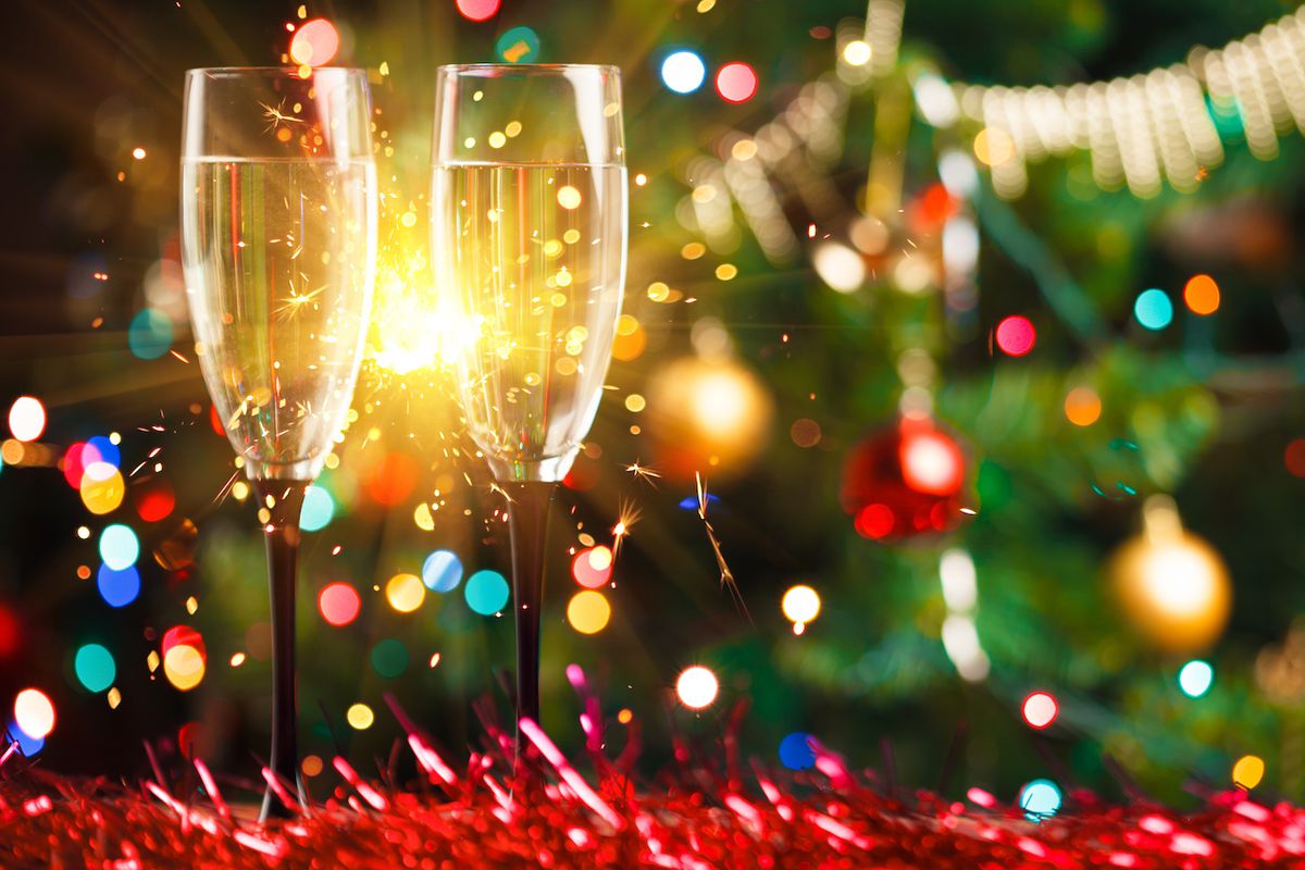 Champaign glasses in front of a Christmas tree