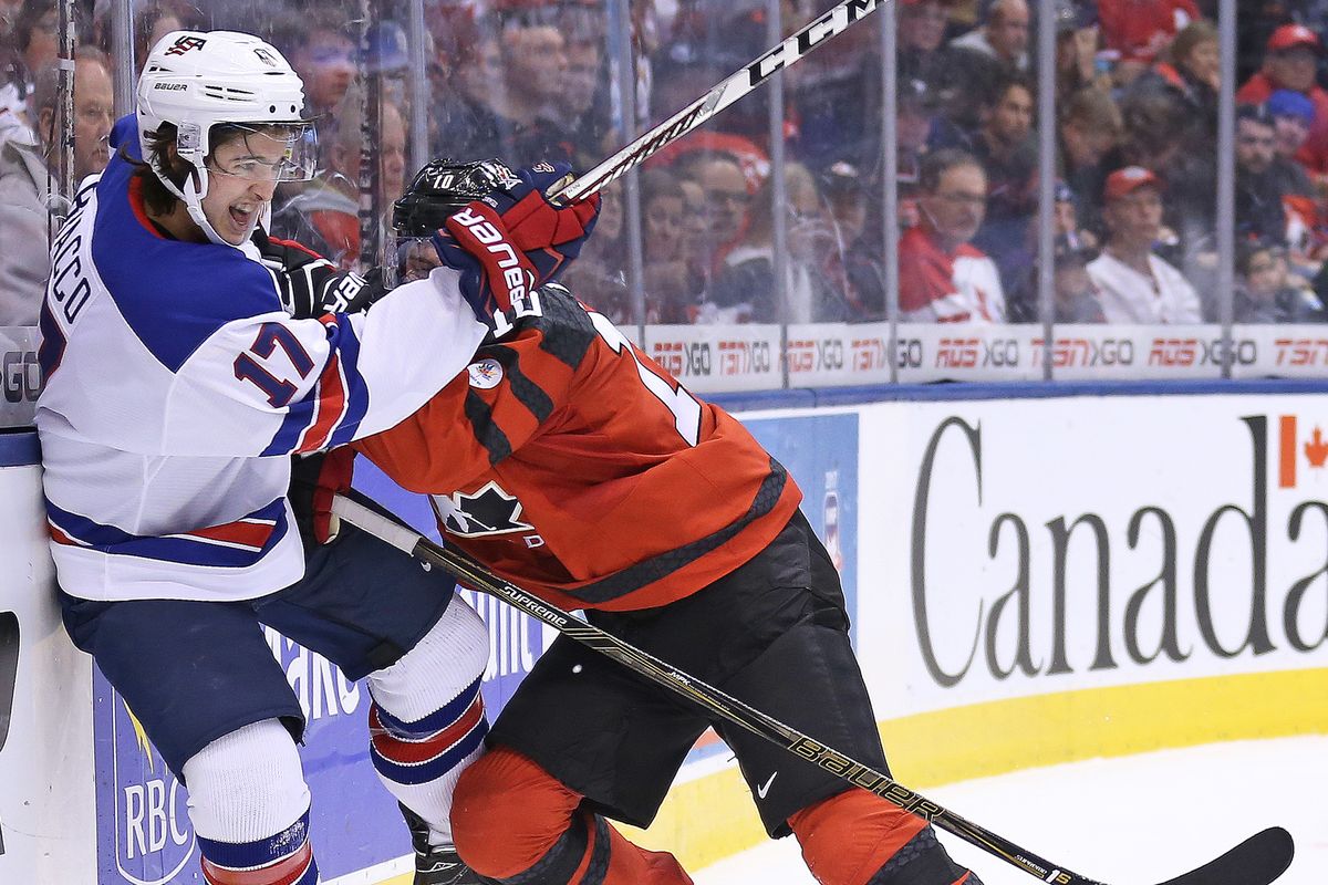 A Canadian hockey player checks an American hockey player