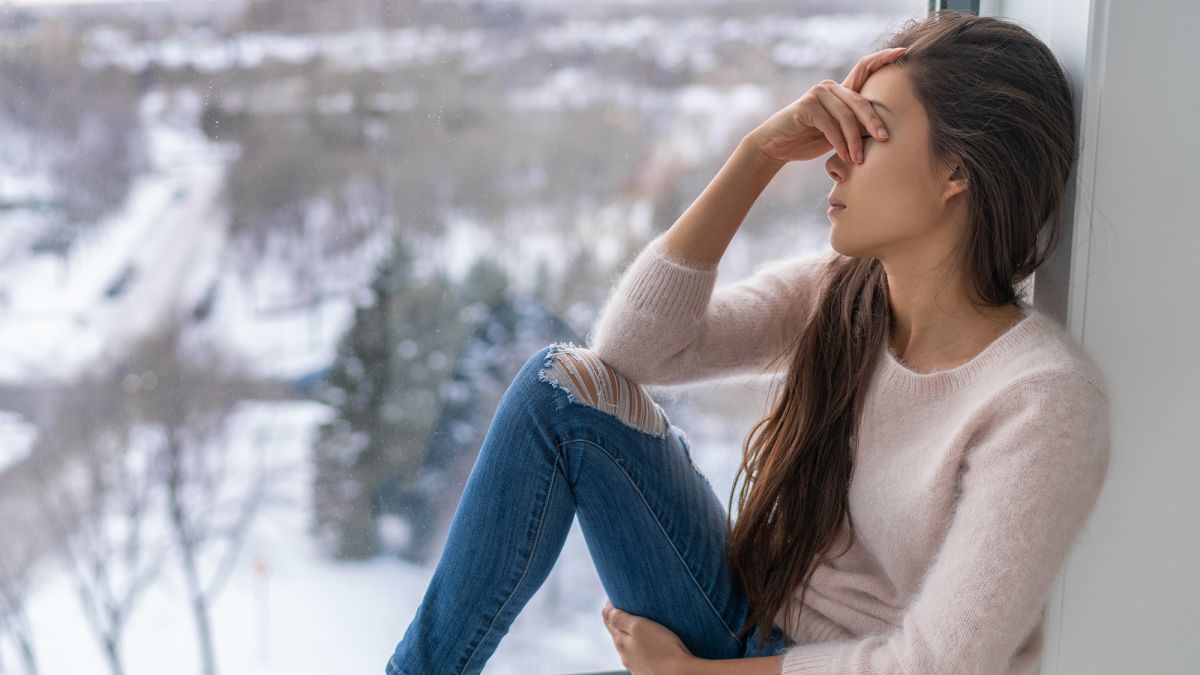 A woman sitting looking sad