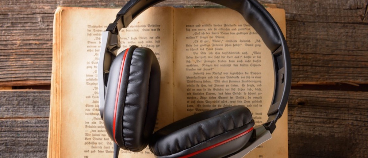 Headphones on top of an open book