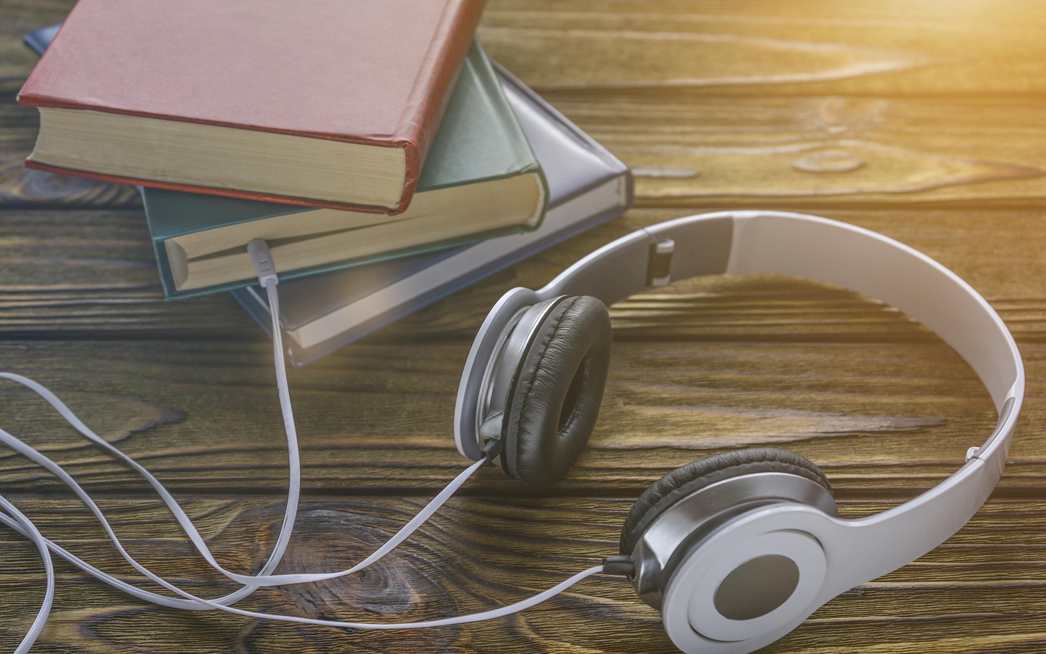 Headphones on top of an open book