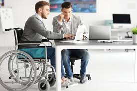 A man in a wheelchair working at a desk