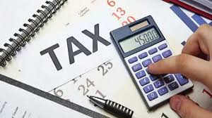Someone using a calculator to do taxes