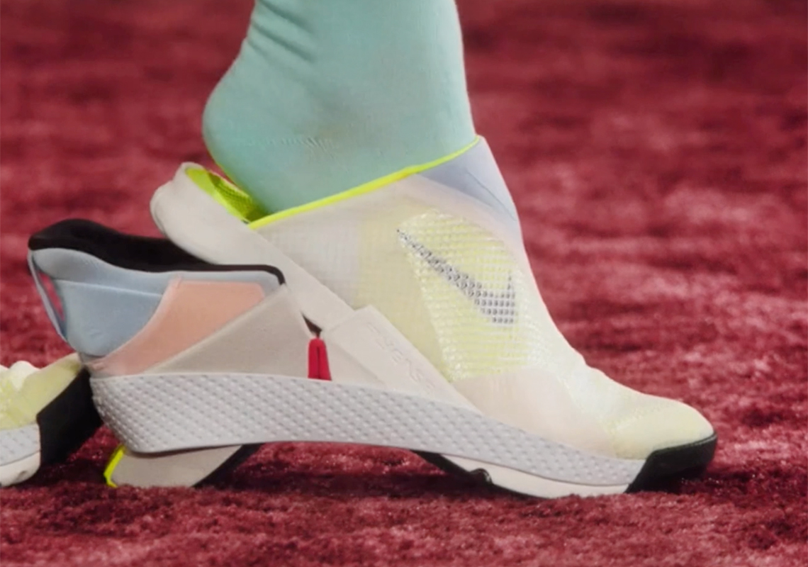 A closeup of a person's foot inserting into a bended Nike shoe hands-free.