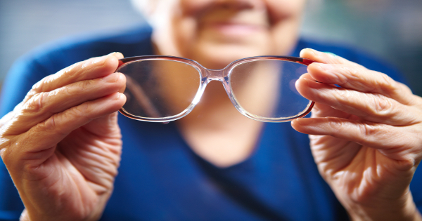 A women looking at her glasses