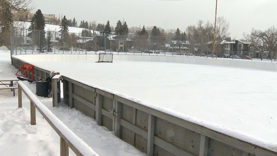 Calgary's outdoor enclosed ice hockey rink with a hockey net in the distance. 