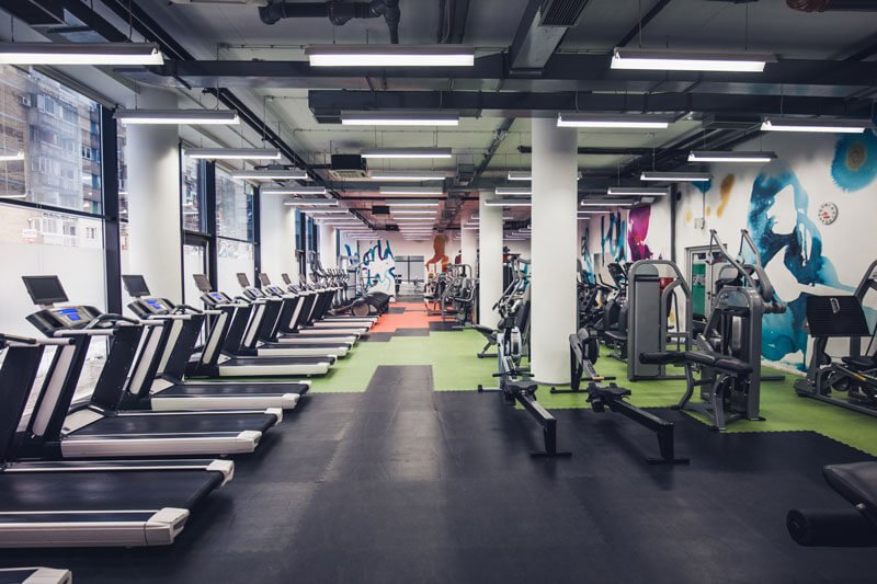 An empty gym with treadmills and other workout machines.