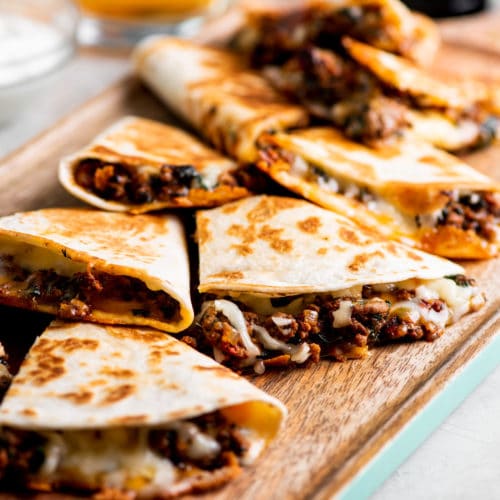 A tray of toasted and cheesy ground beef quesadillas.