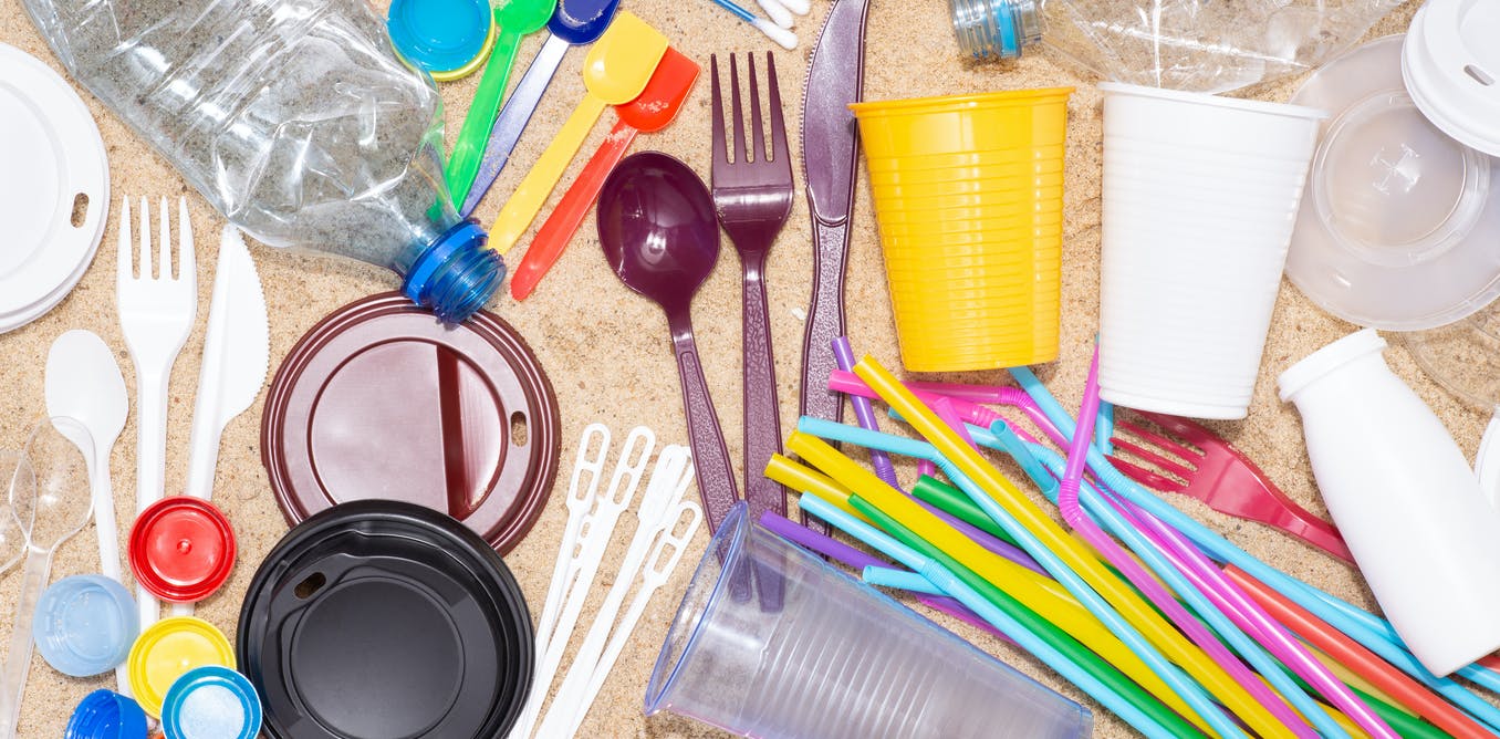 A photo of various single use plastics suchs as bottles, straws, and containers.
