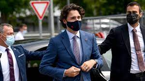 Justin Trudeau flanked by two bodyguards