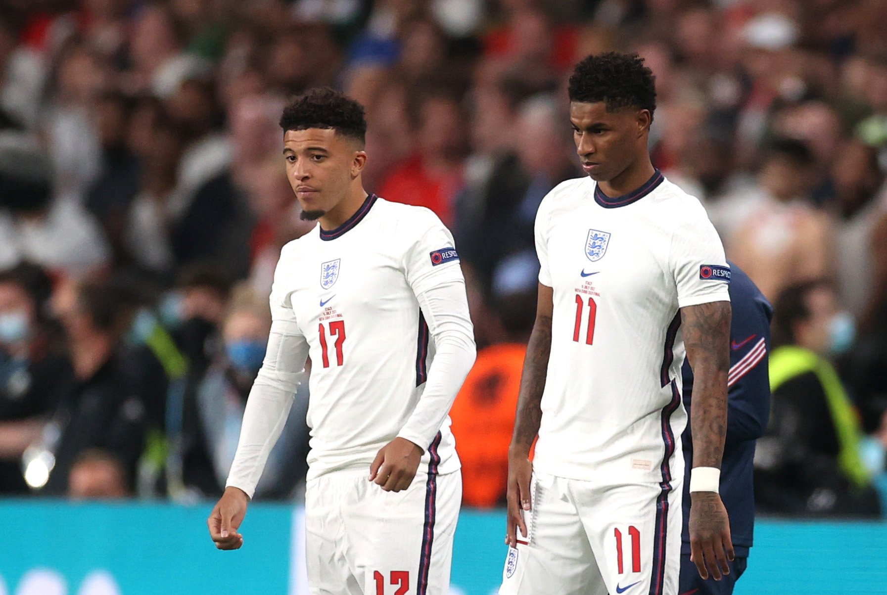 England's Marcus Rashford and Jadon Sancho standing on the football pitch.