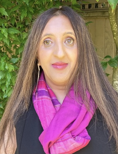 A photo of Anu Pala smiling outside. 
